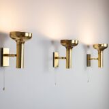 Set of three brass adjustable wall lamps