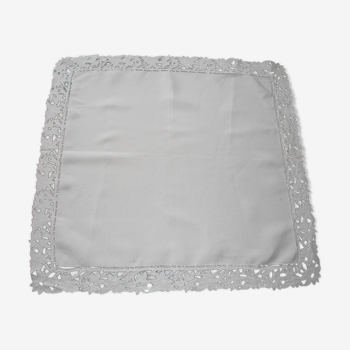 Old square tablecloth decorated with lace