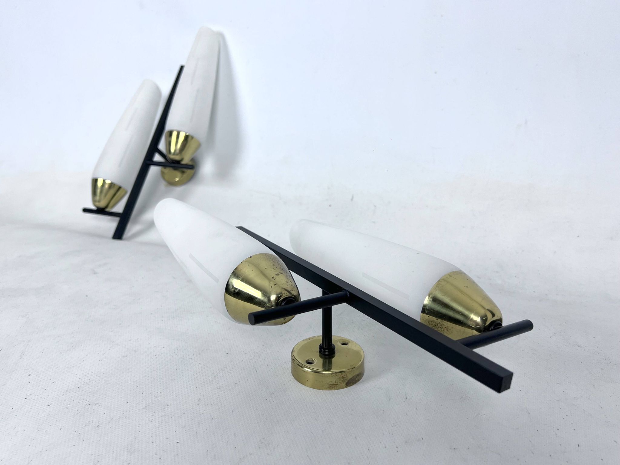 Mid-Century pair of double lights sconces in brass and opaline glass. Italy 1950s