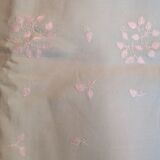 Old embroidered tablecloth in light green color