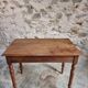 Antique French writing table in walnut with a drawer, circa 1900.