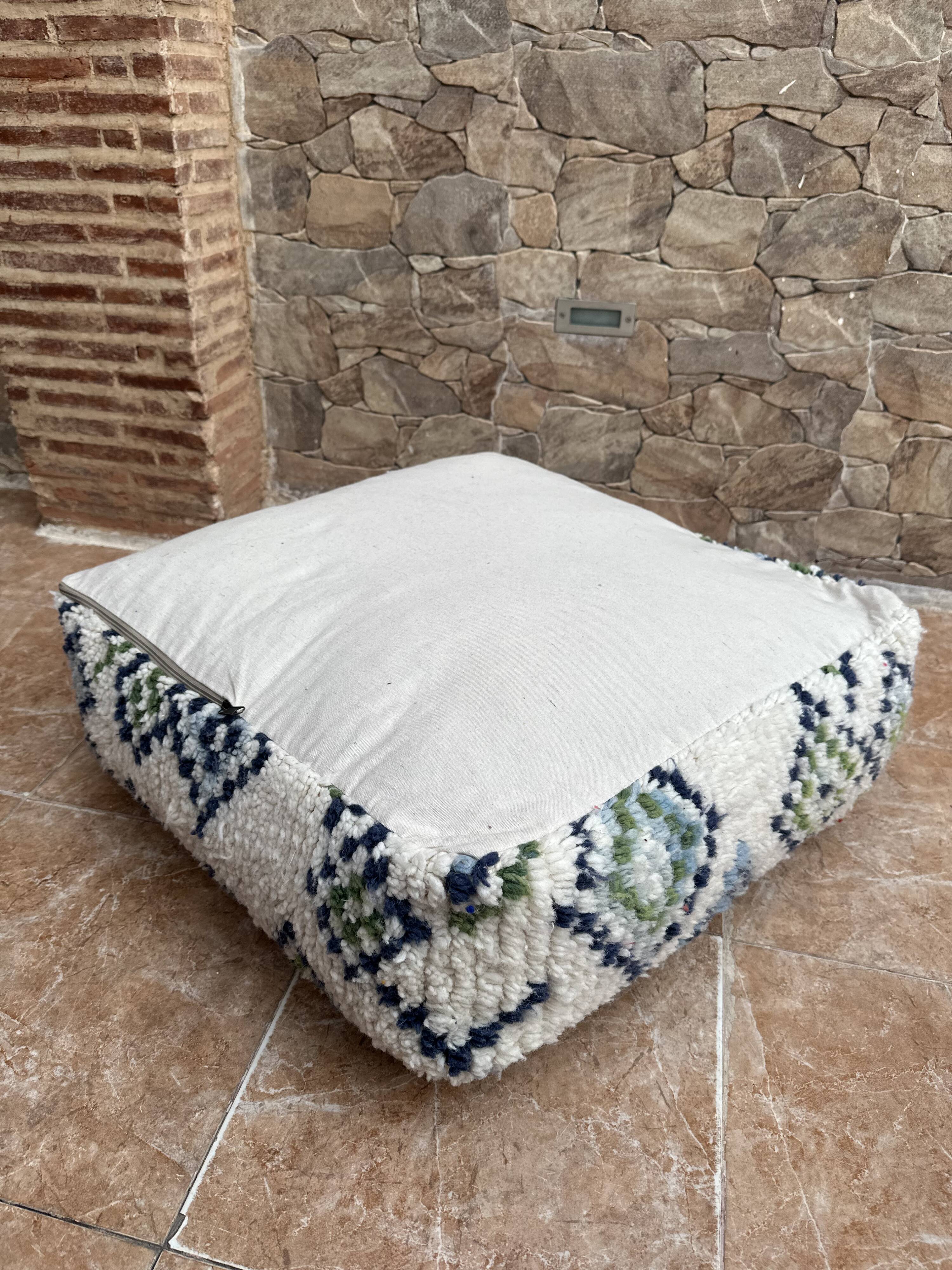 Berber floor pouf: Handwoven Moroccan wool cushion.