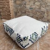 Berber floor pouf: Handwoven Moroccan wool cushion.