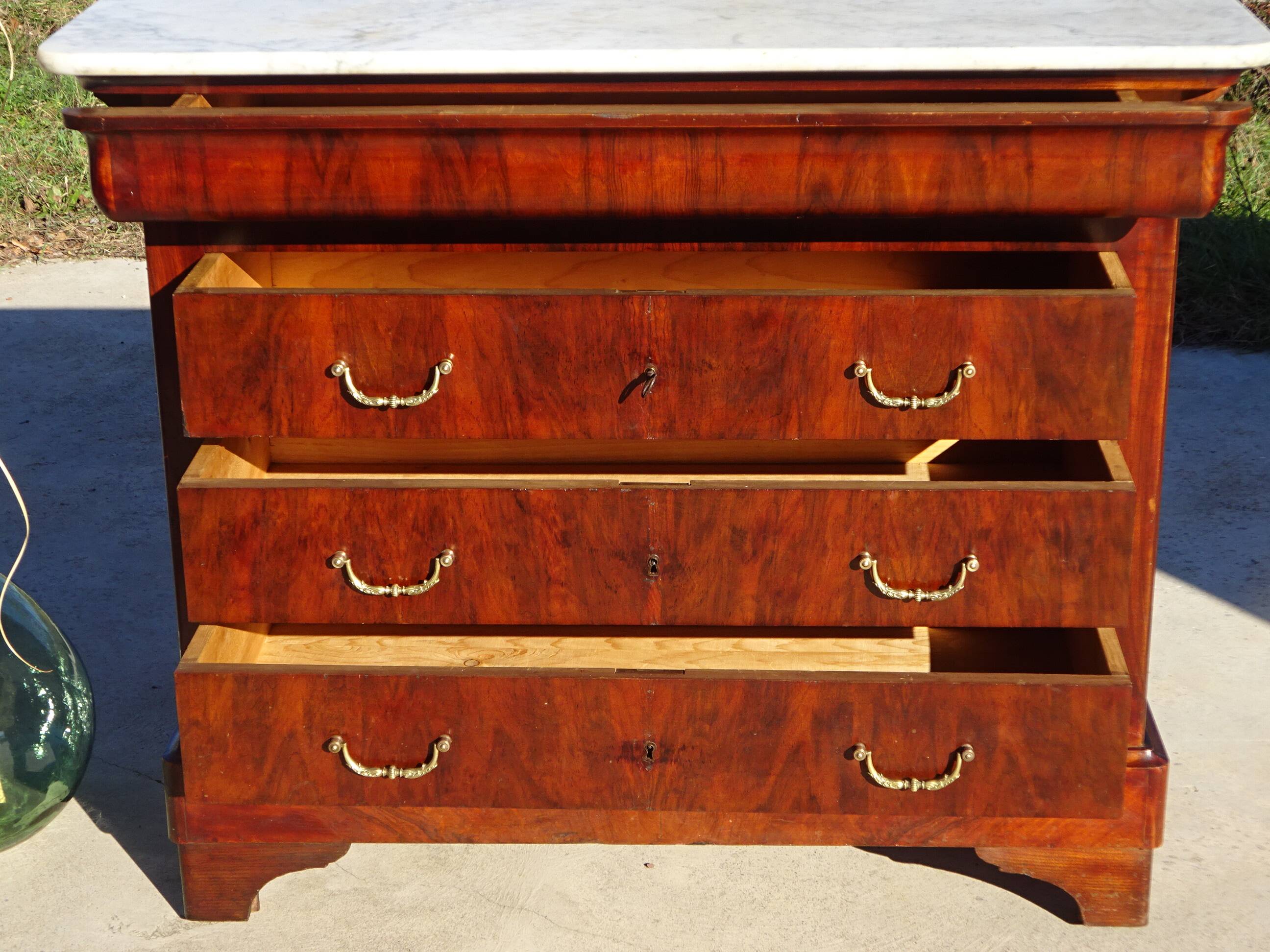 Antique mahogany chest of drawers with white marble.