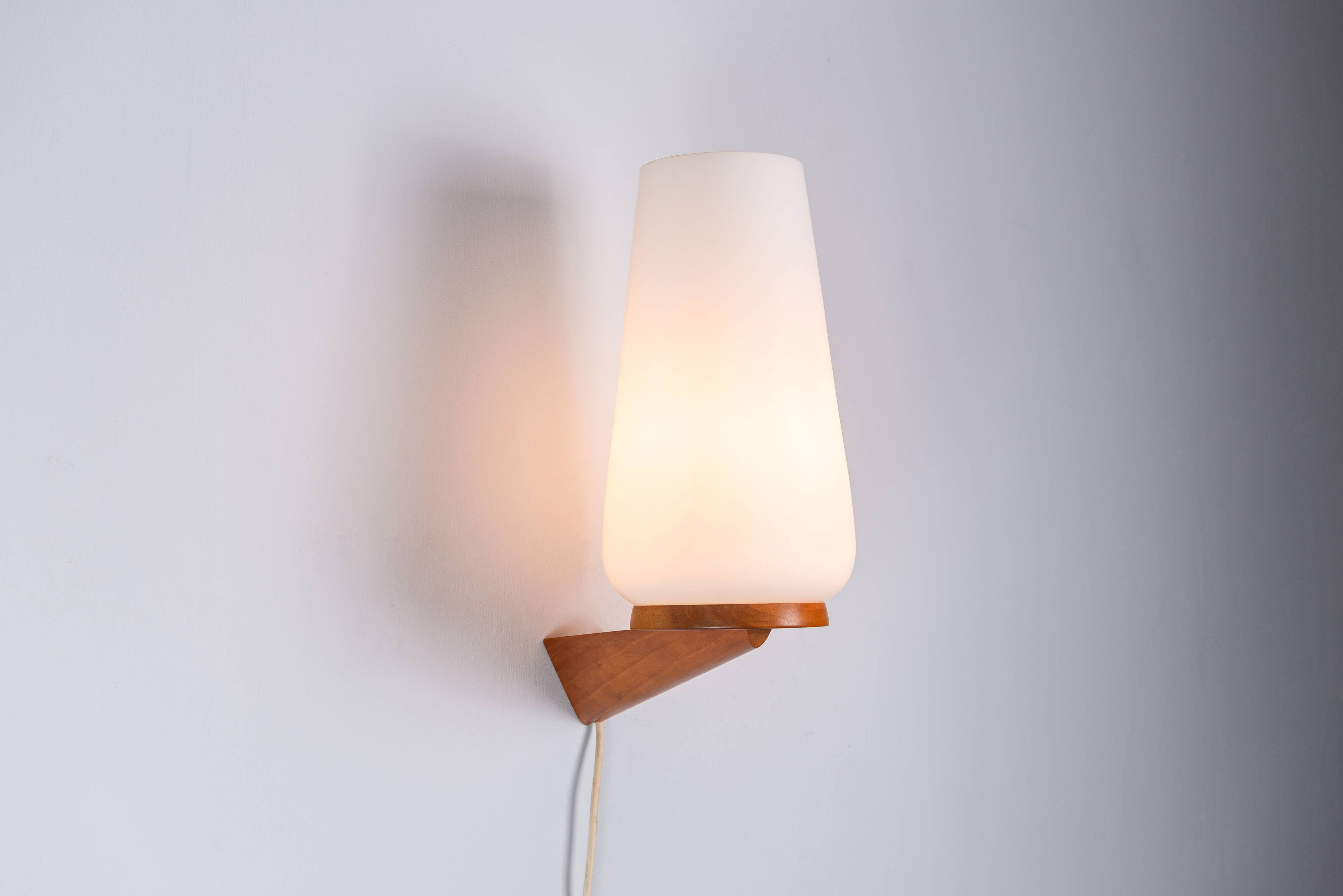Wall lamp with opal glass shade on wooden base by Philips