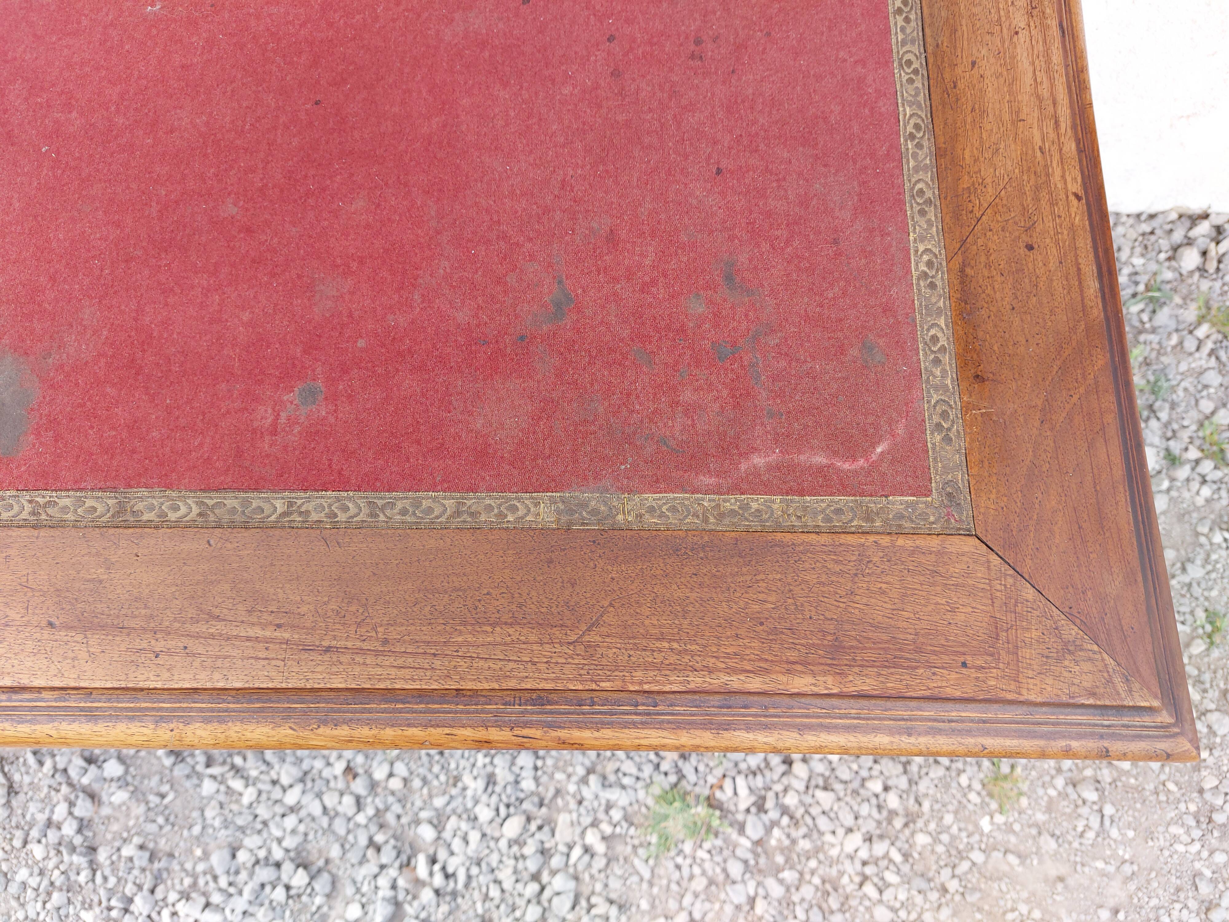 Old wooden desk, red felt top