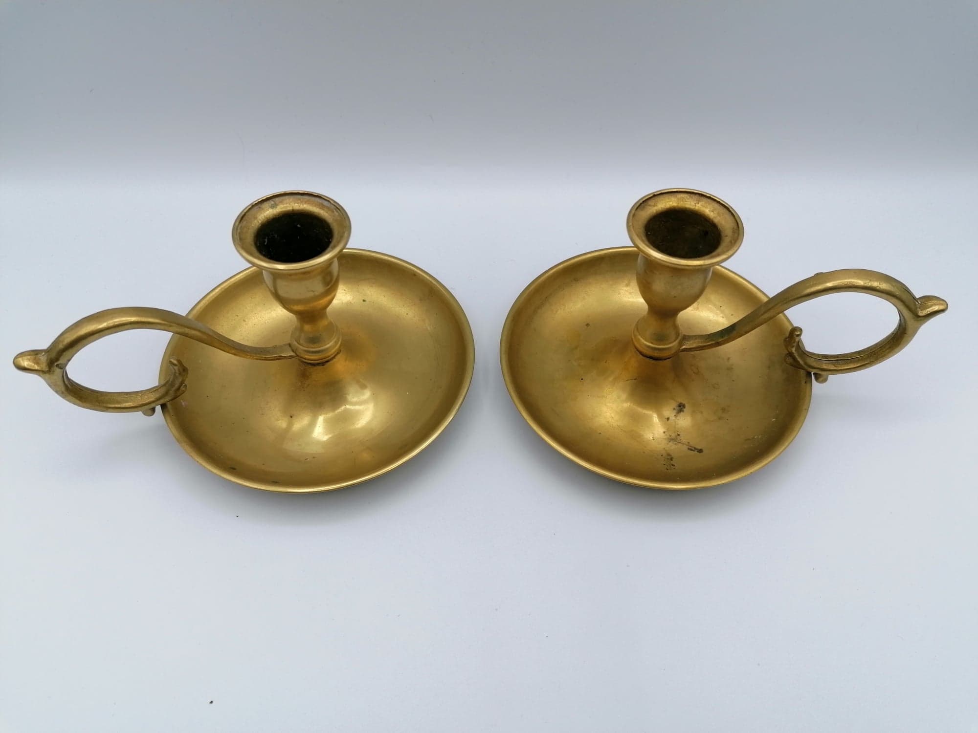 Pair of brass hand candlesticks