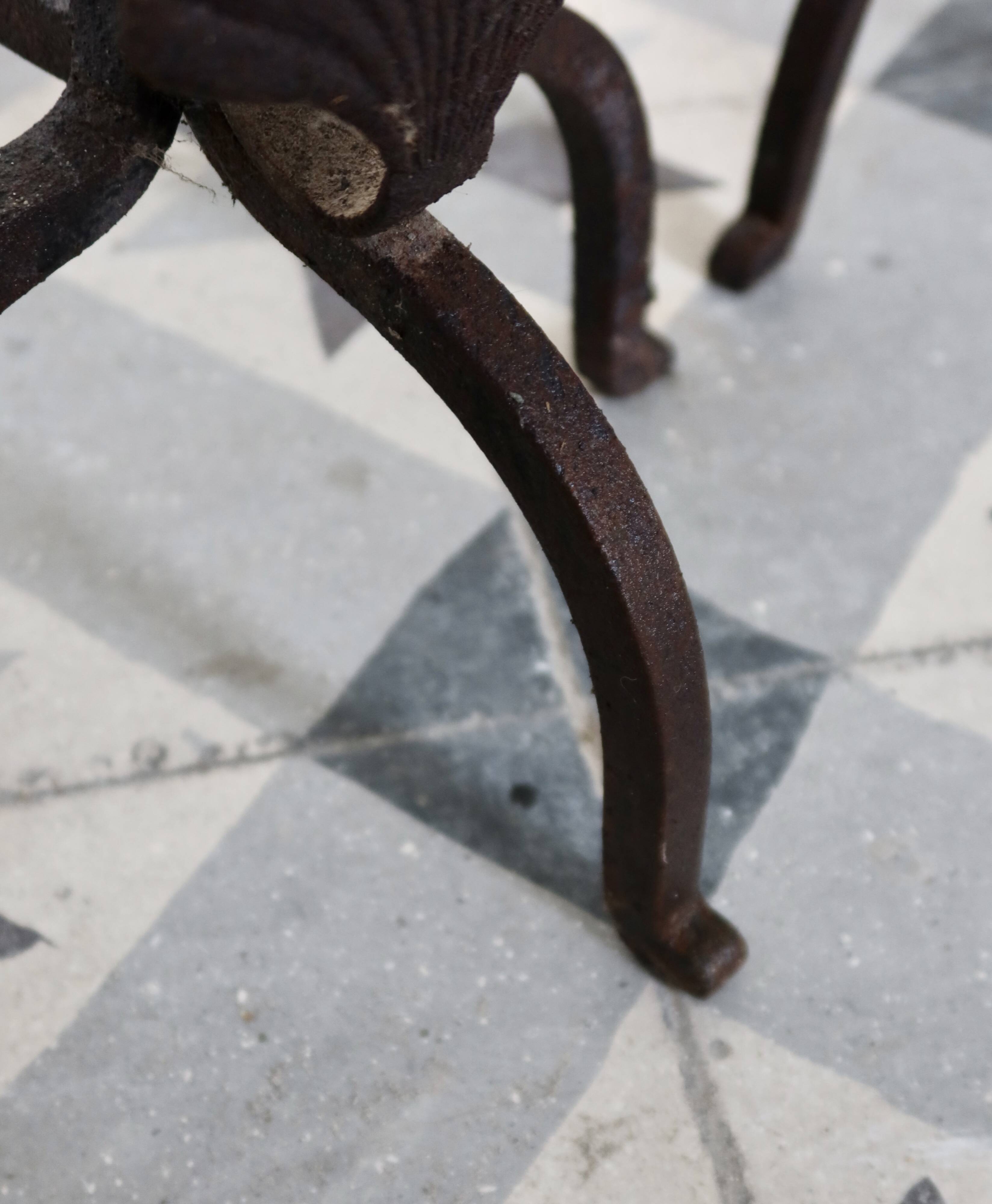 Vintage metal and cast iron fire dogs with shell motif.