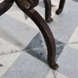 Vintage metal and cast iron fire dogs with shell motif.