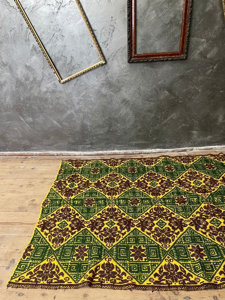 Green and yellow handmade rug with delicate colourful flowers