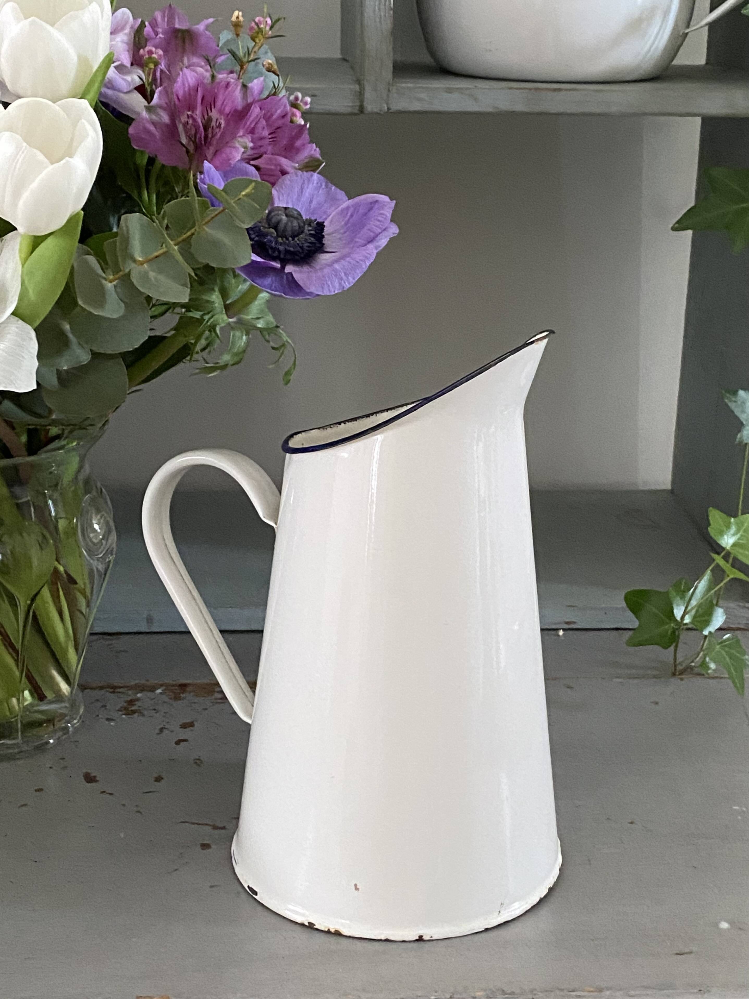 Old white enameled pitcher
