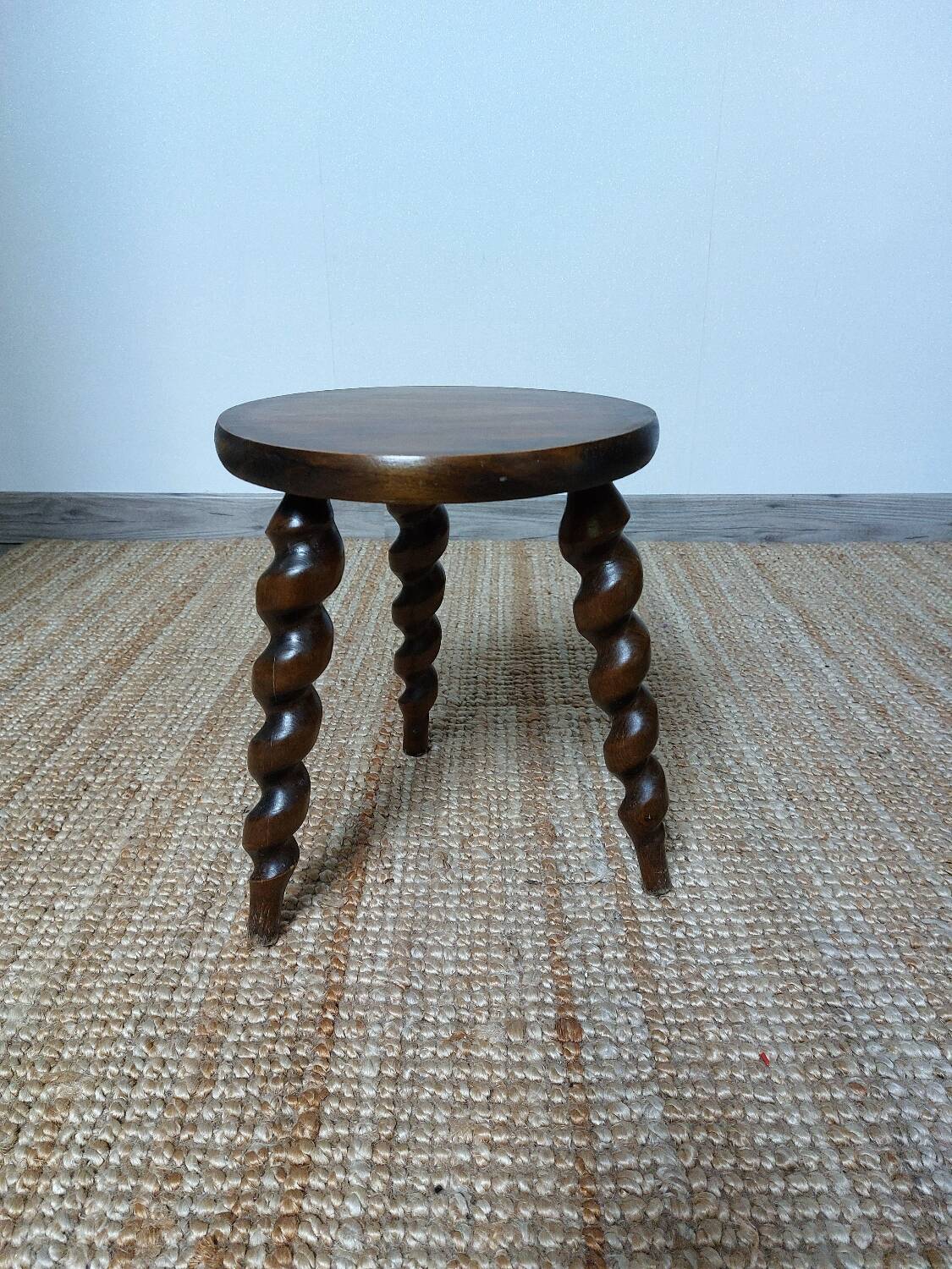 Wooden tripod stool with twisted legs