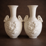 Paire de vases en biscuit decor putti et tête de bélier