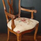 Upholsterer armchair covered with a publisher fabric with a central floral pattern