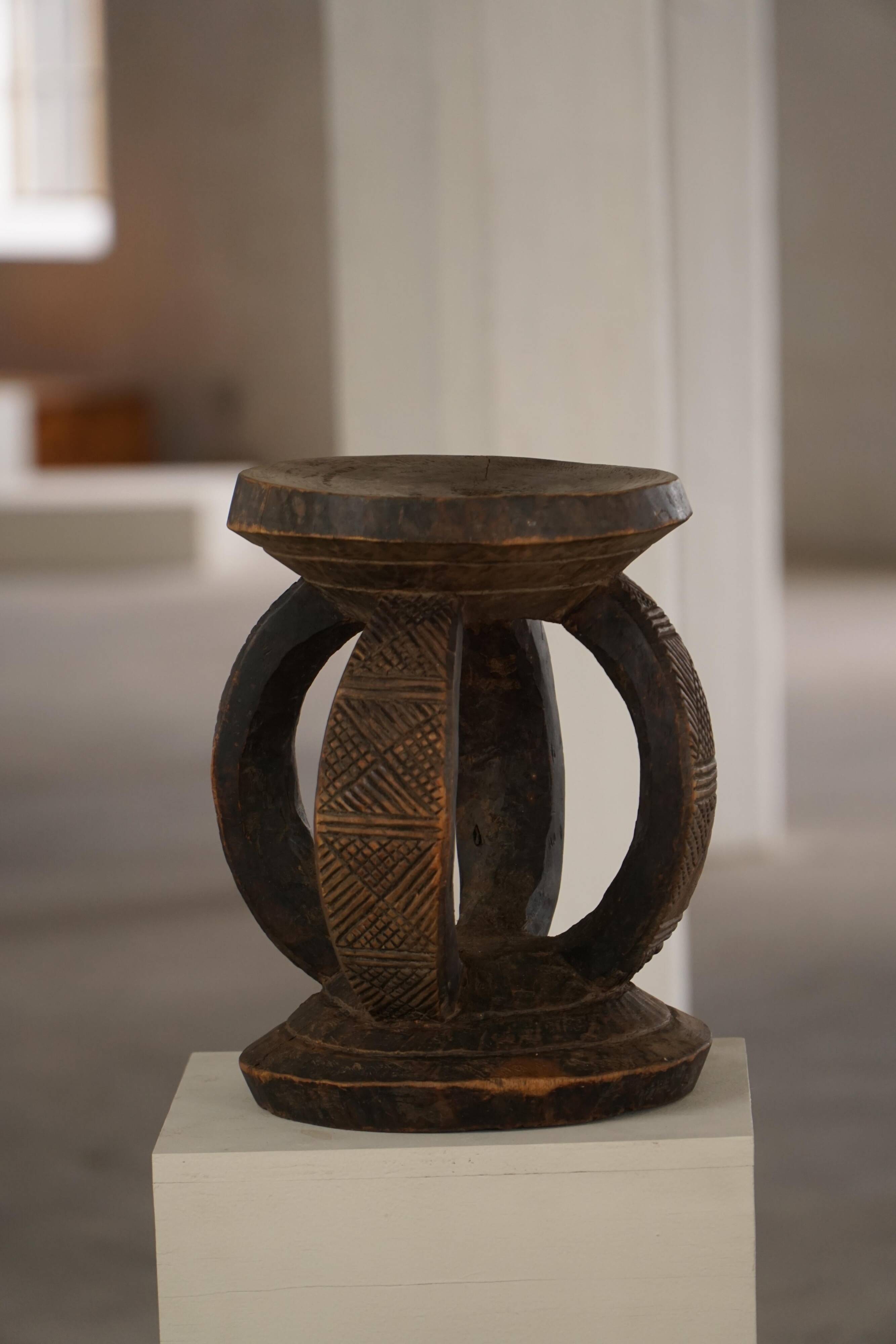 Antique wooden stool hand-carved by the Dogon people of Africa, Wabi-Sabi style, mid-20th century.