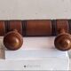 Wall-mounted coat rack with 8 turned wooden hooks in faux bamboo style.