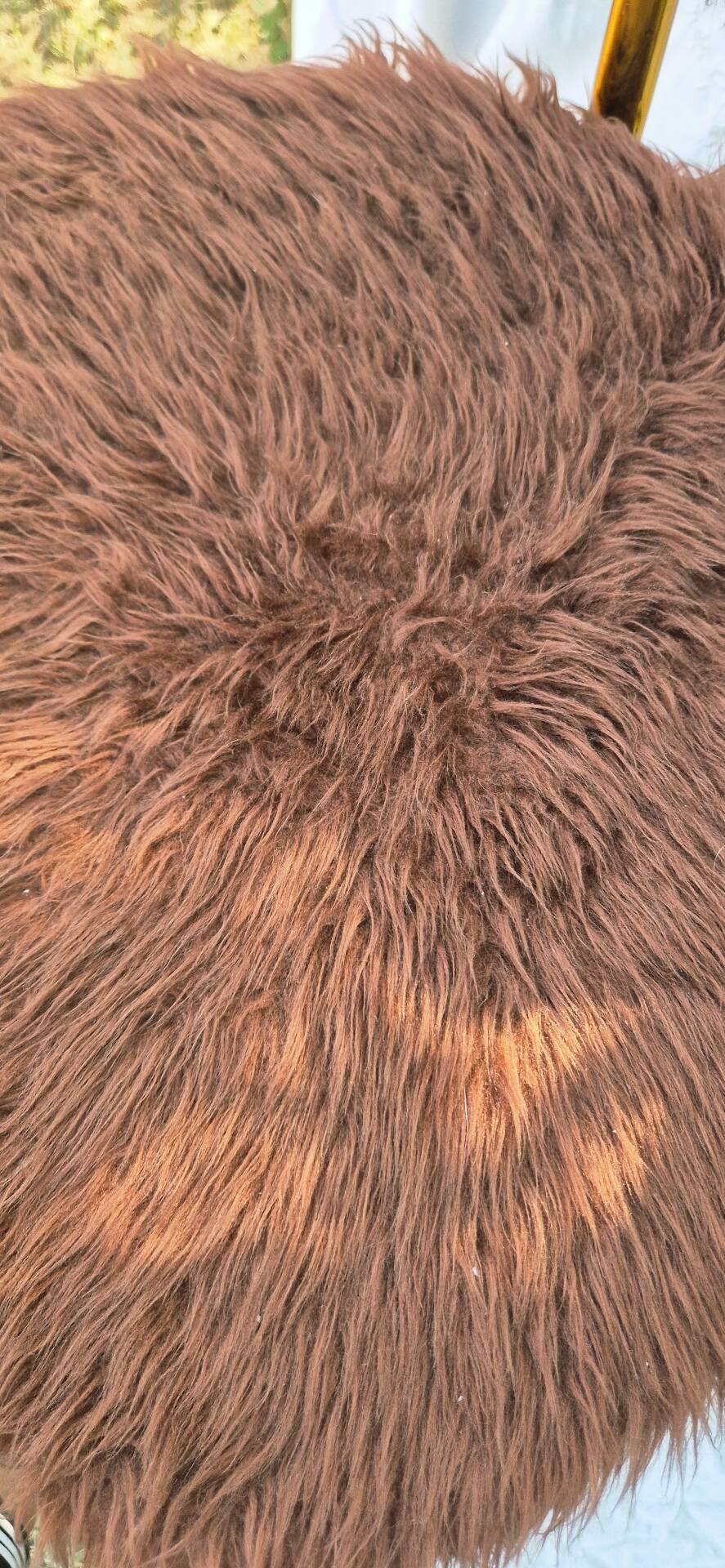 Vintage shaggy chair in faux fur with golden metal legs.
