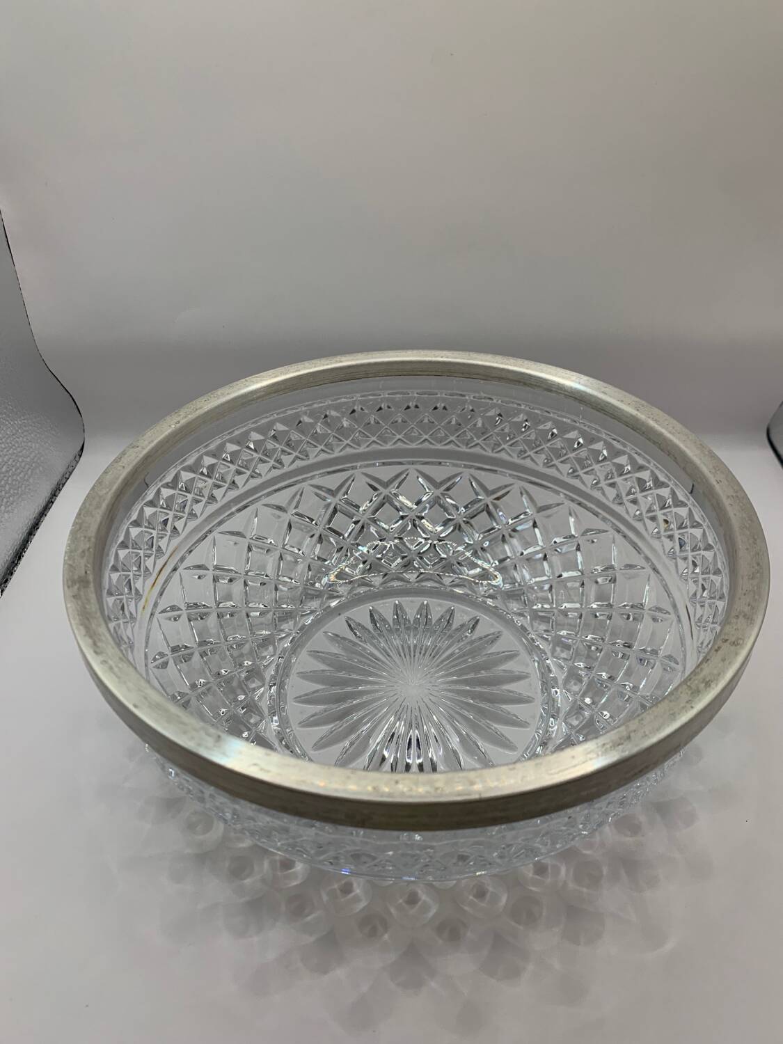 Chiseled glass (crystal?) salad bowl with silver metal edge