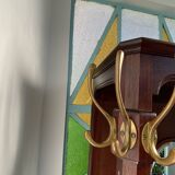 Antique wooden coat rack with mirror and shelf.