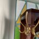 Antique wooden coat rack with mirror and shelf.