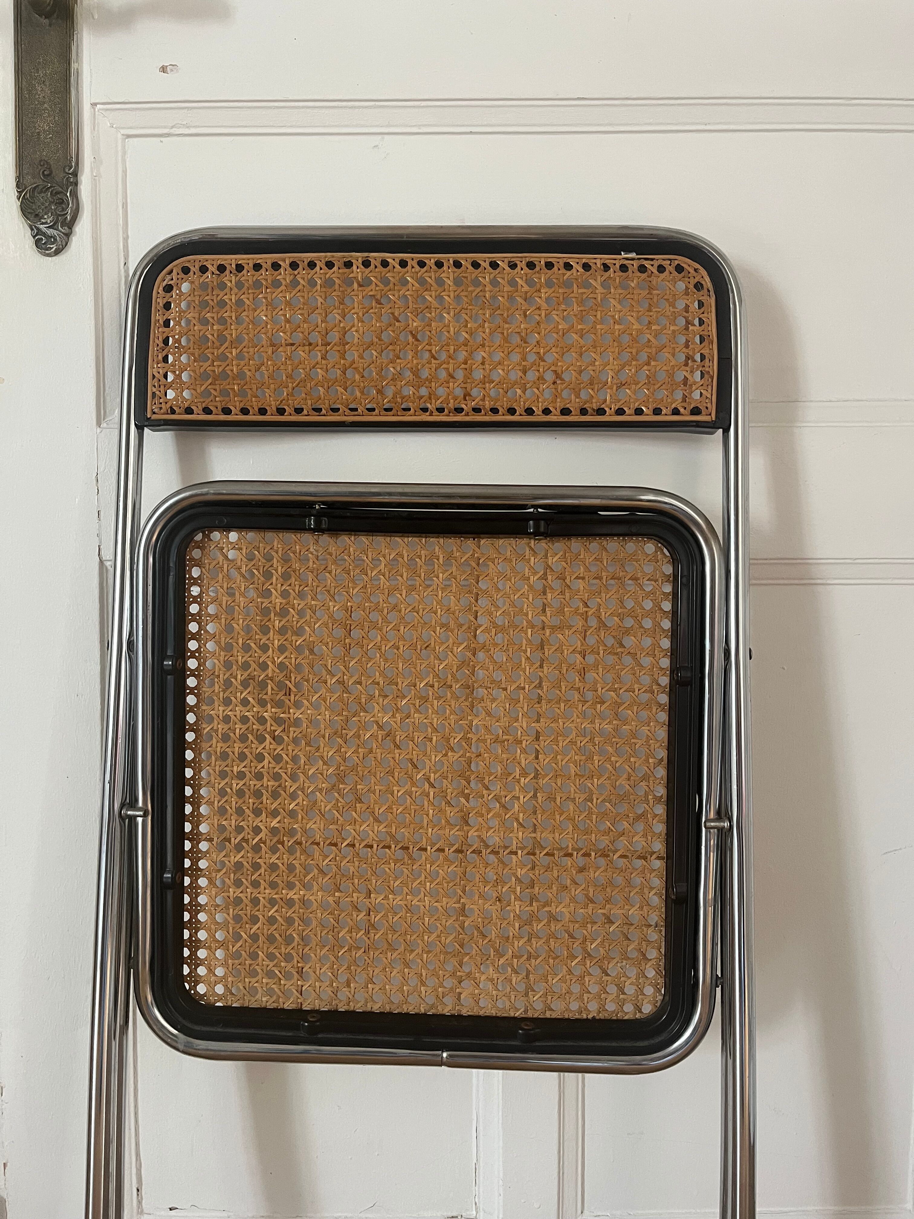 Vintage folding chair in metal and cane.