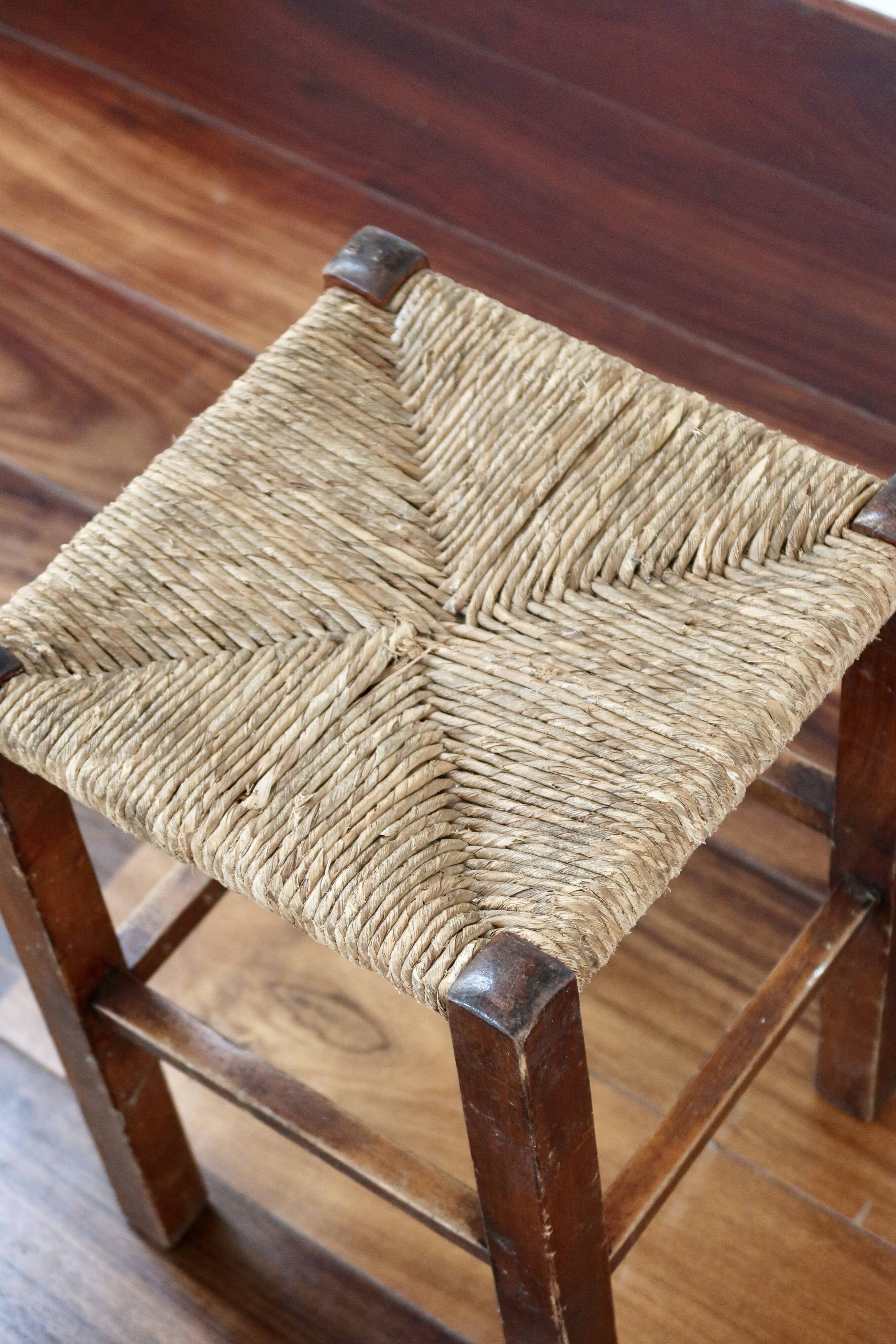 Rustic old stool made of wood and straw.