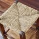 Rustic old stool made of wood and straw.
