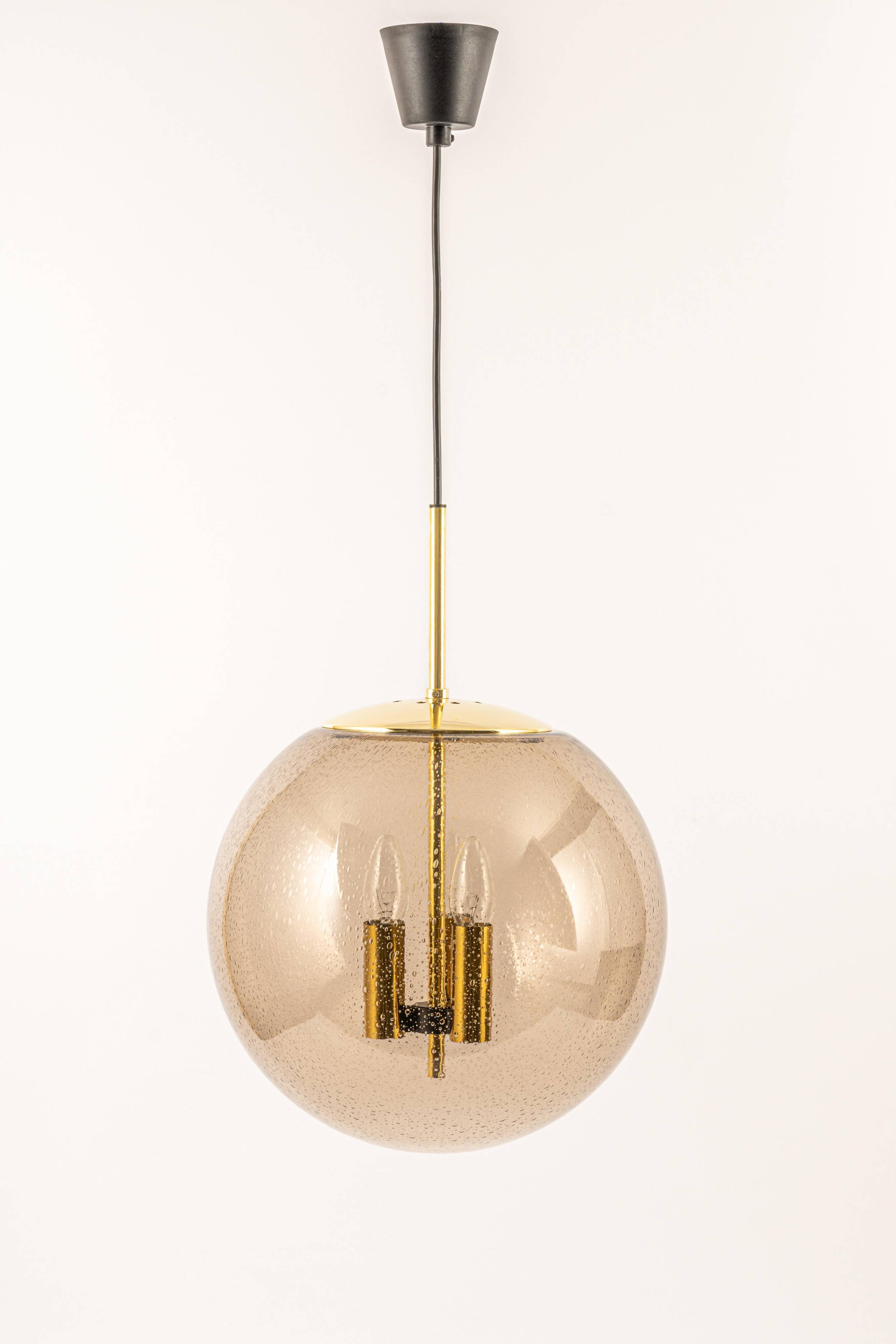 Large Limburg pendant light in brass with smoked glass ball, Germany, 1970s.