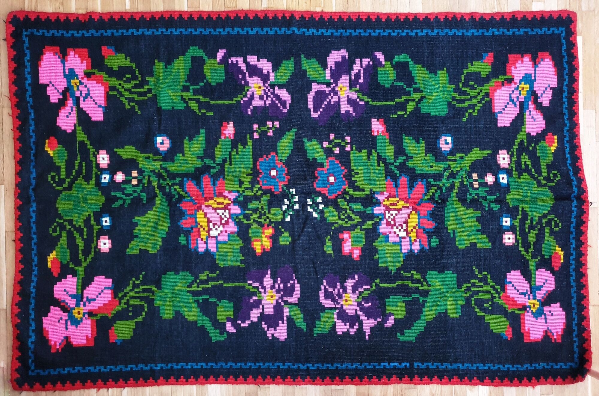 Handwoven summerish floral rug, black background with colorful delicate flowers 152x238cm