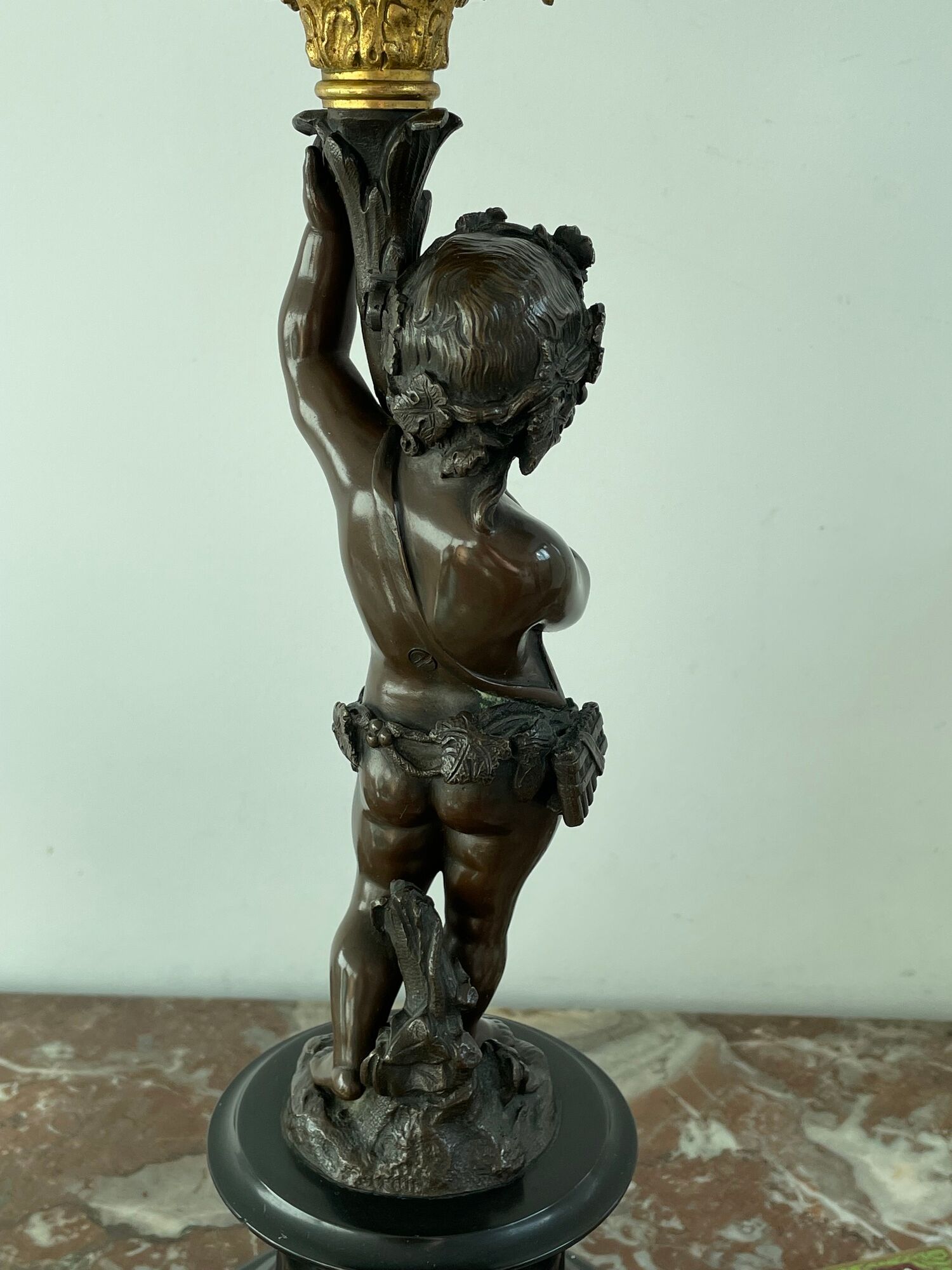 Candelabra with cherub in patinated bronze
