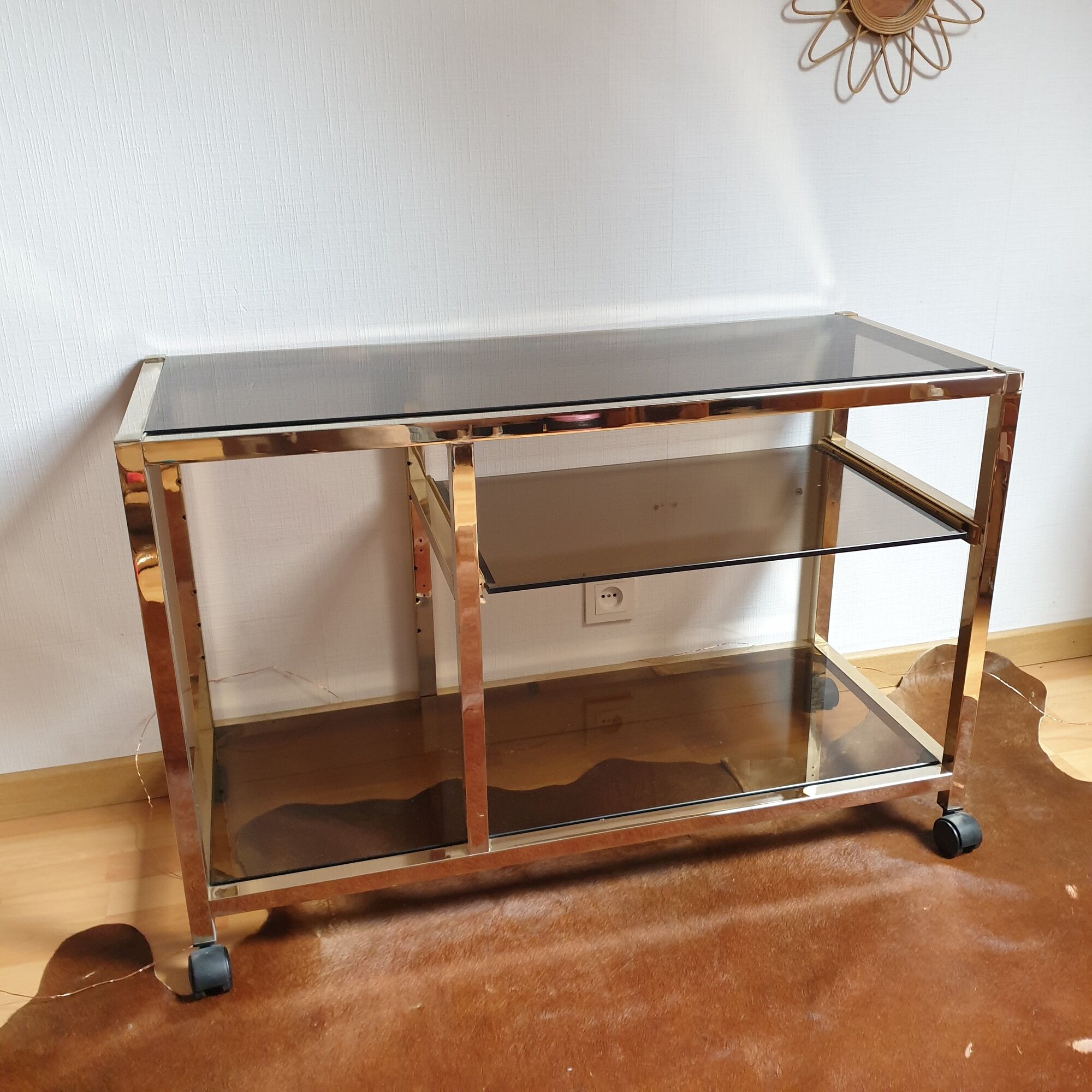 Service table with vintage brass wheels / smoked glass