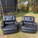 Pair of black imitation leather armchairs