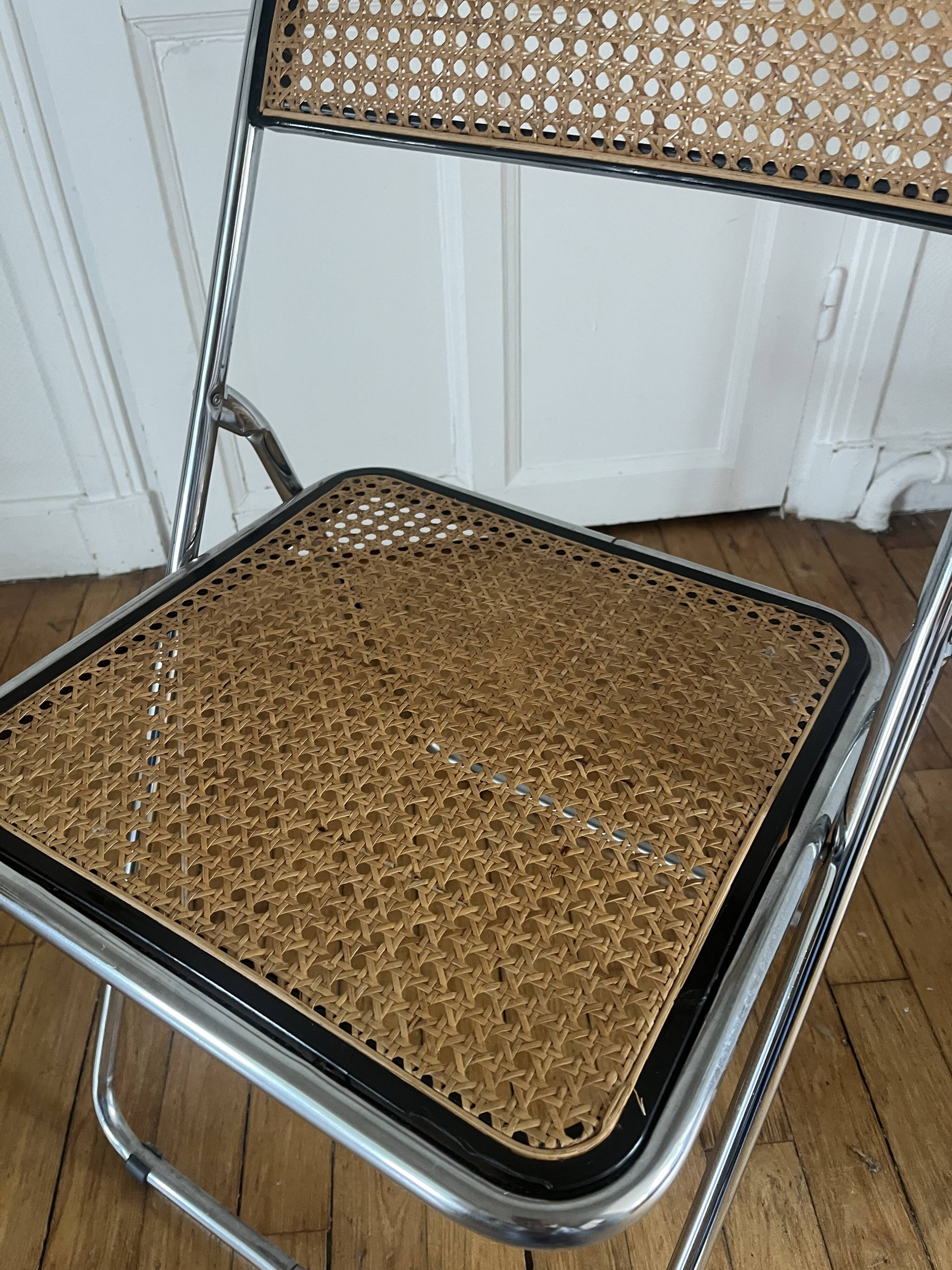Vintage folding chair in metal and cane.