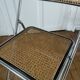 Vintage folding chair in metal and cane.