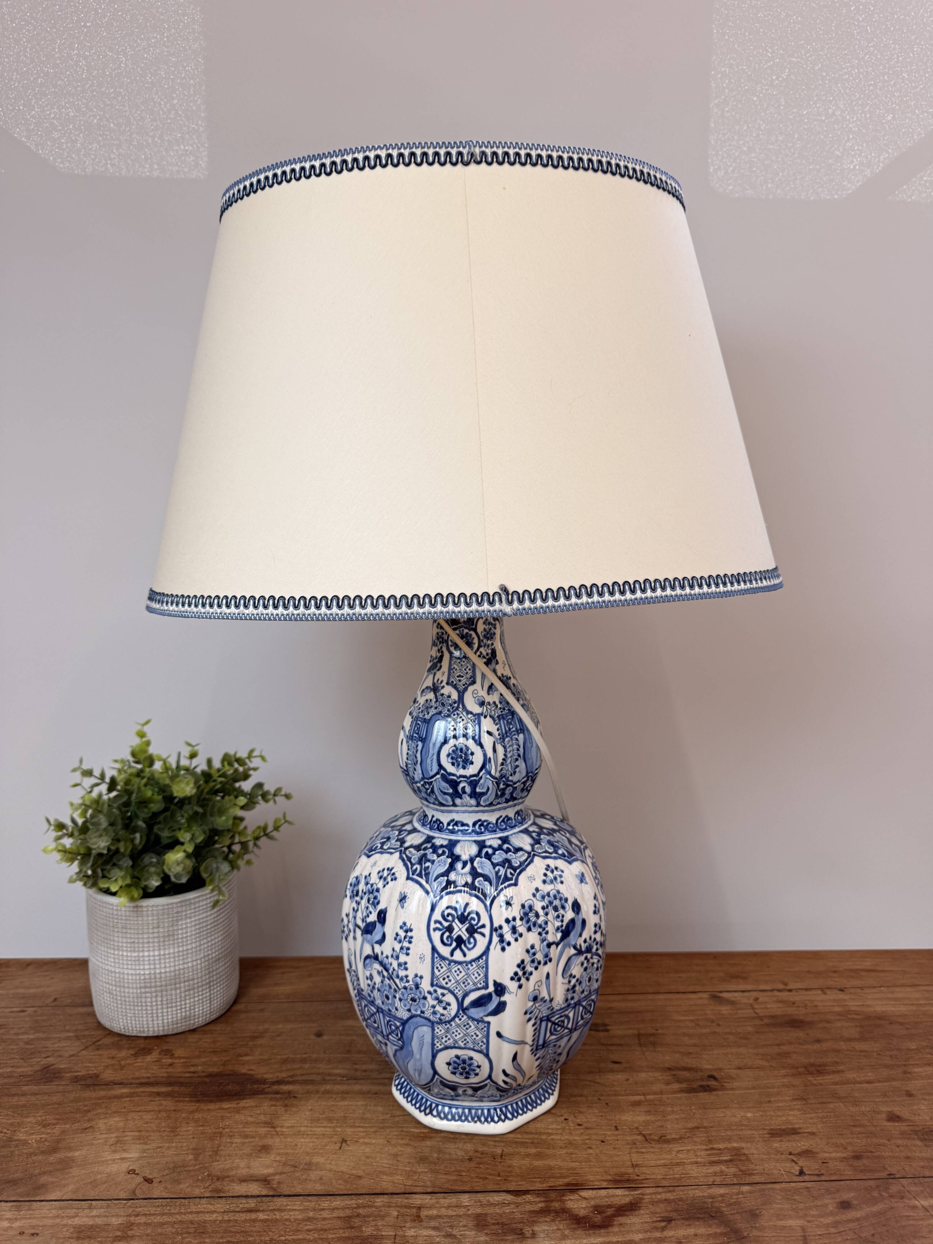 Blue and white Delft ceramic table lamp decorated with birds and flowers.