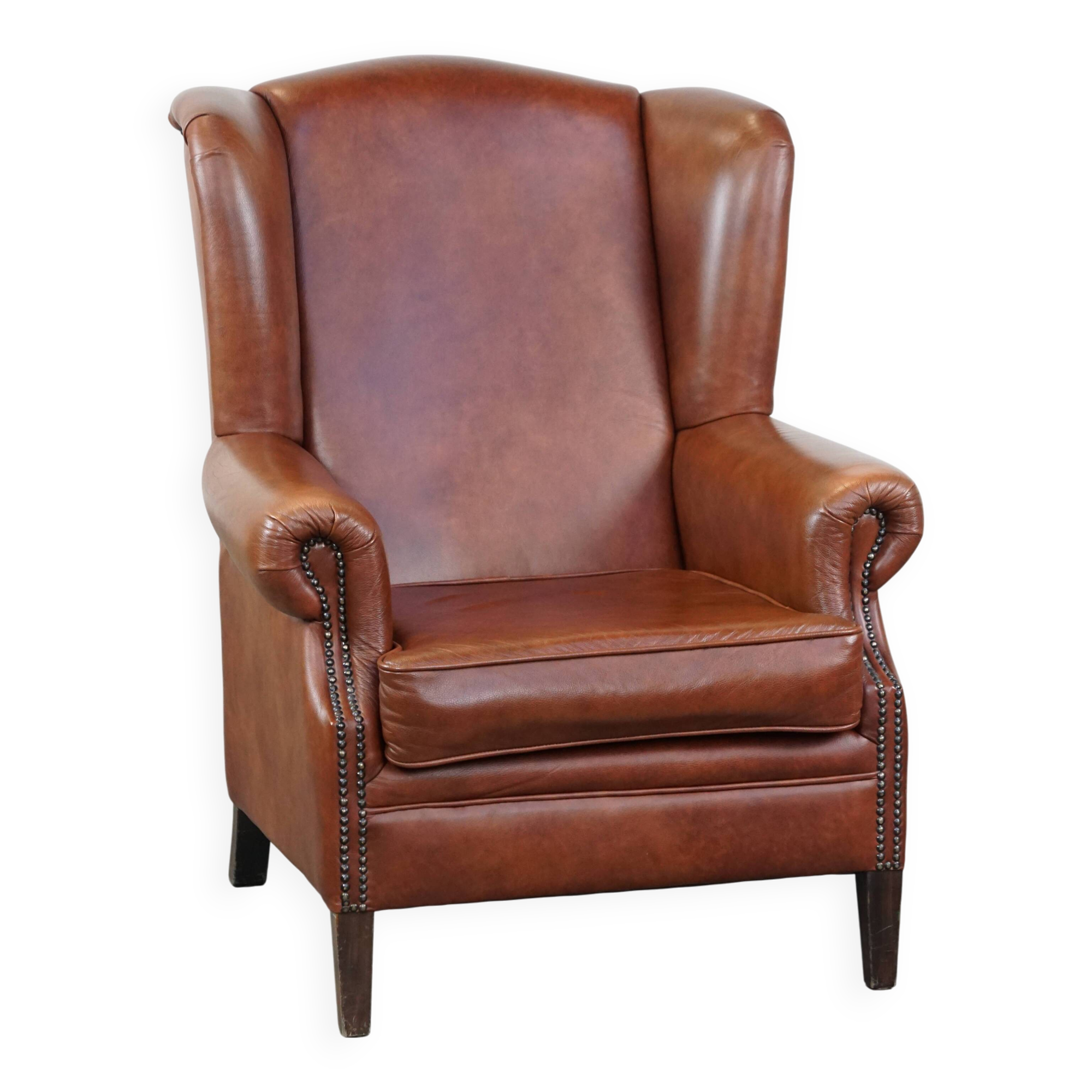 Cognac-colored cowhide wingback chair
