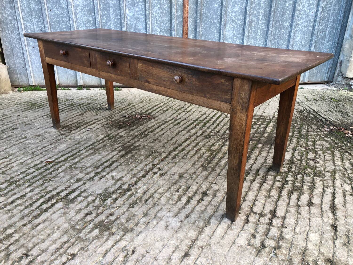 Antique chestnut farmhouse table with 3 drawers on the front.
