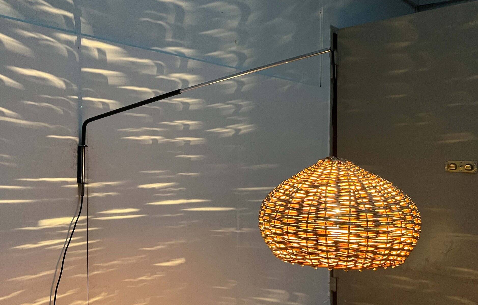 Mid-century modern Danish extendable cantilever wall lamp with a rattan shade, 1960s.