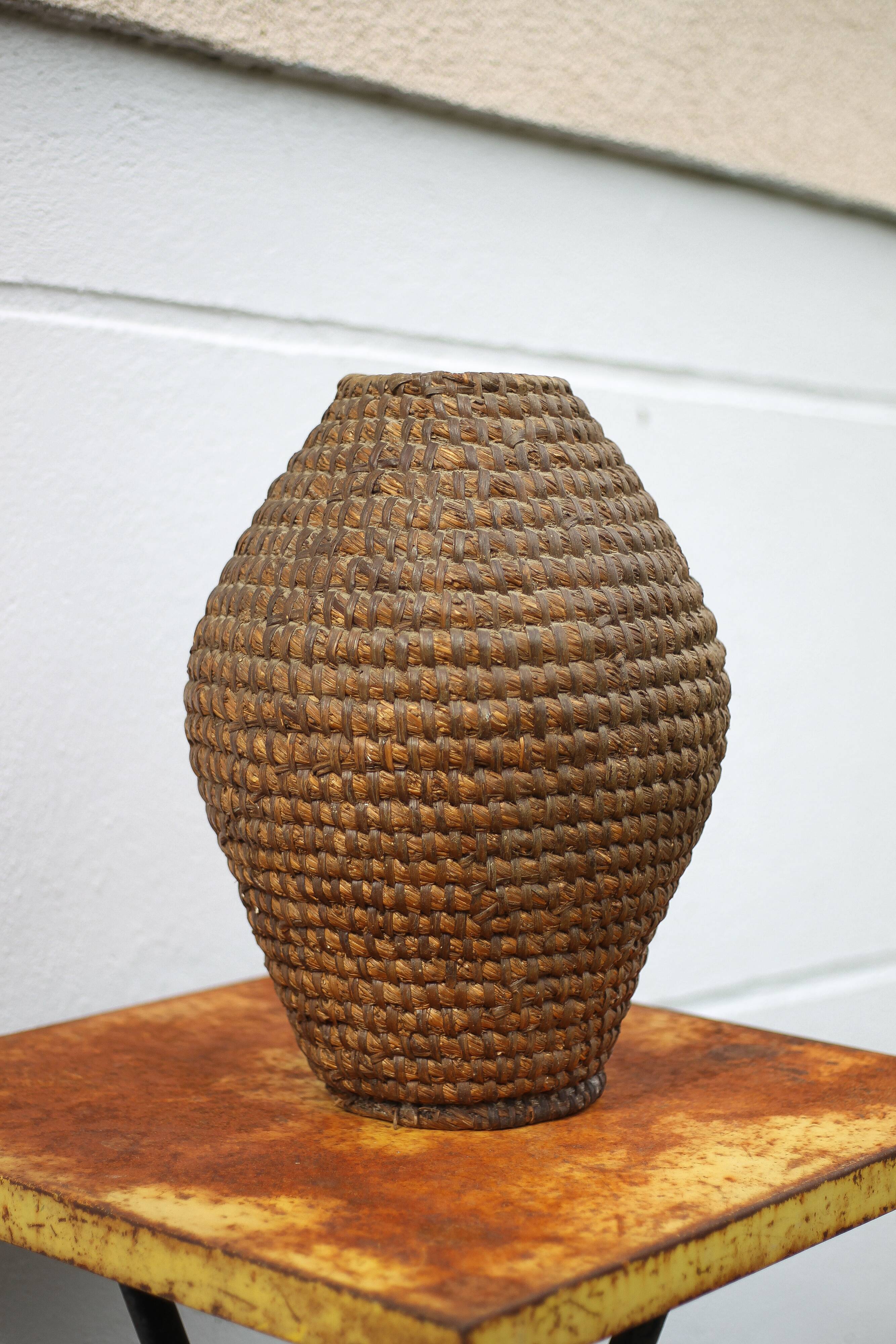 Old basket, burgundy straw and bramble, woven basket, interior decoration