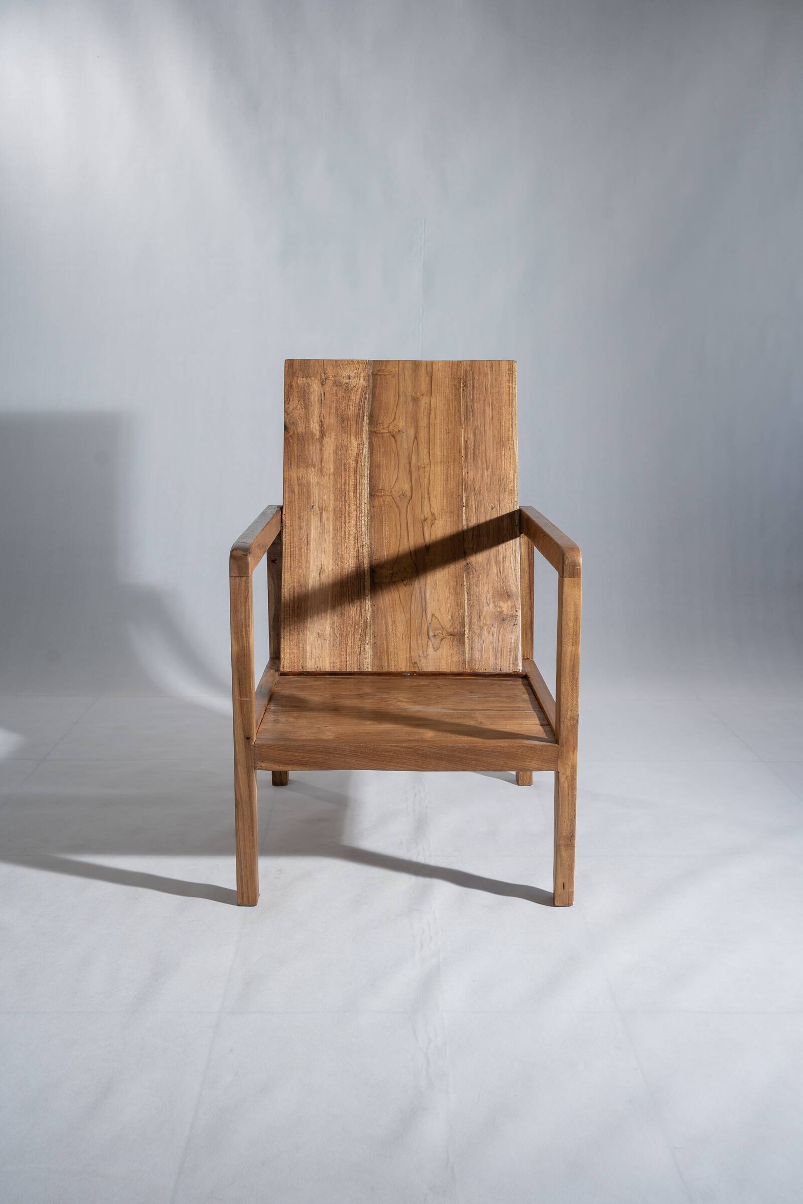 Large armchair in natural wood (teak) with a minimalist design.