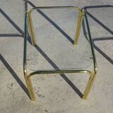 Nested tubular tables in gold metal.