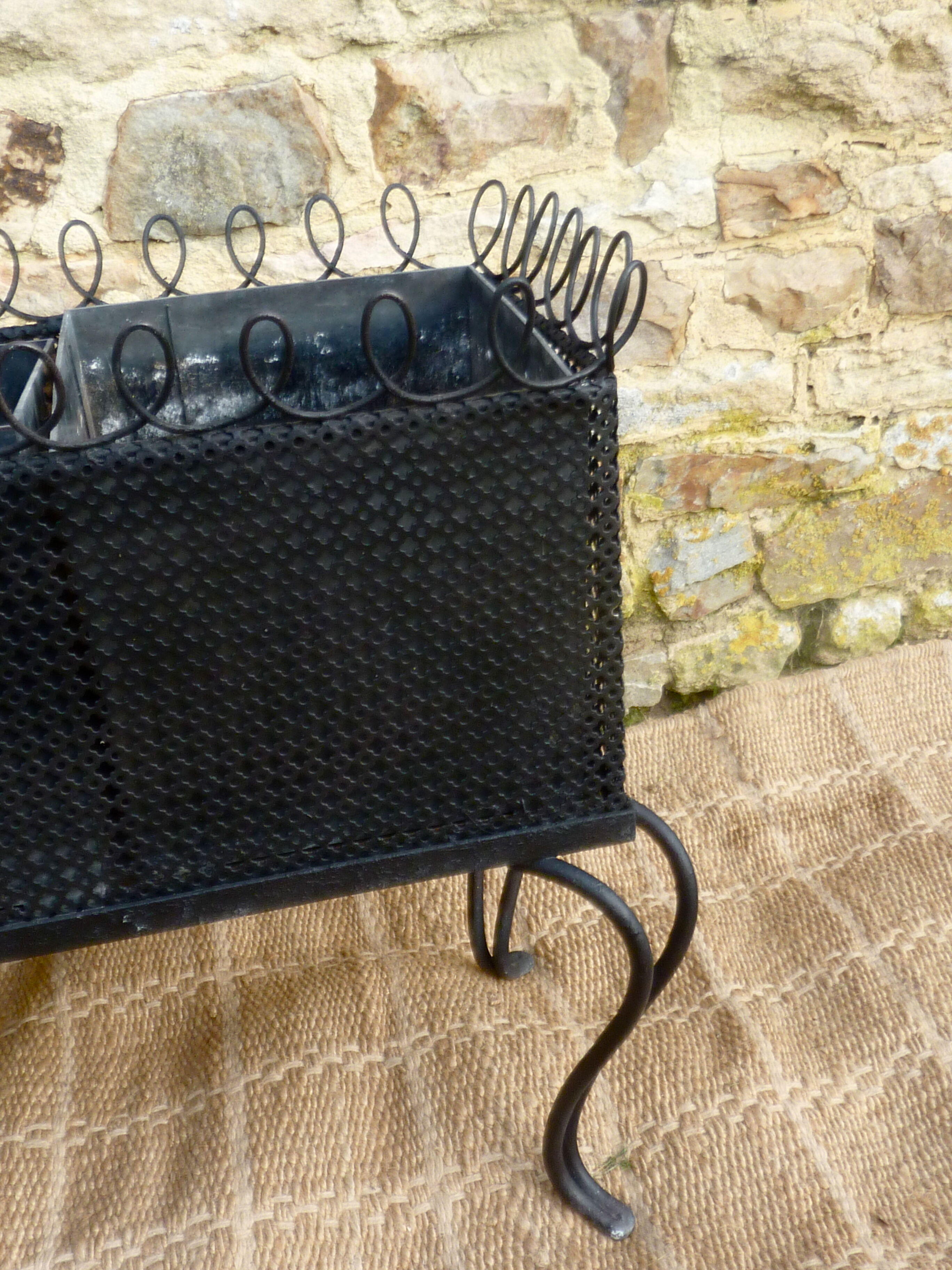 Black perforated metal planter from the 1950s
