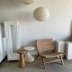 Reclining armchair in natural wood and woven rattan
