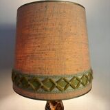 Old lamp with carved wooden base representing a wise man