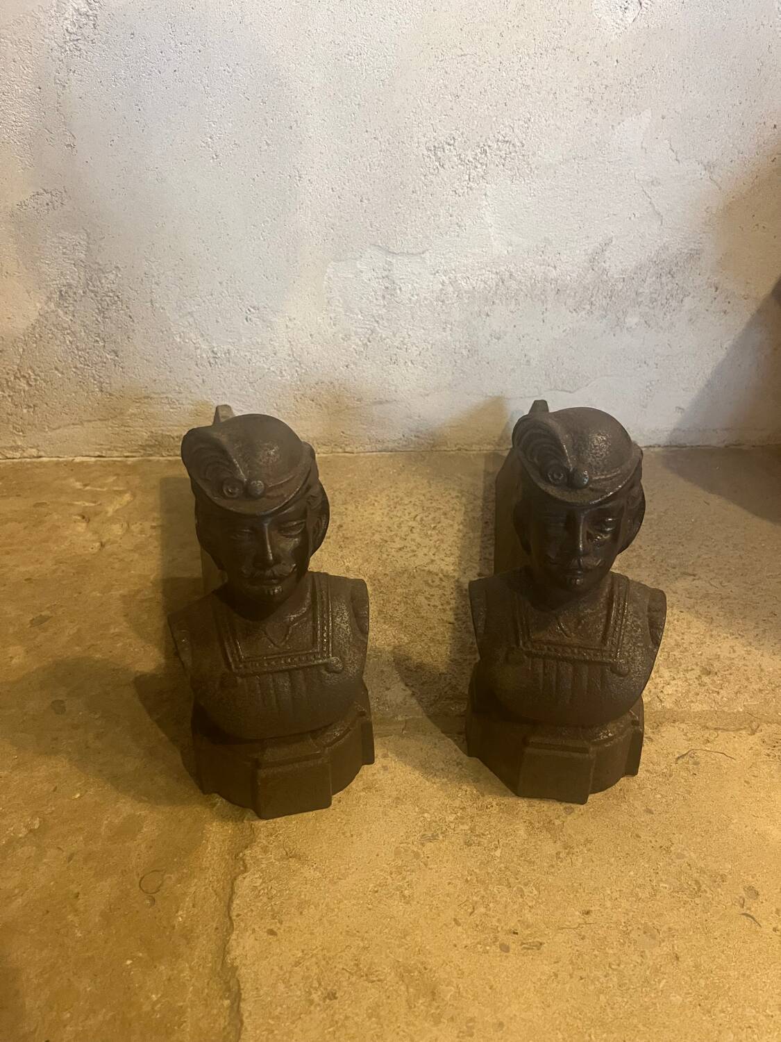 Pair of cast iron andirons with face