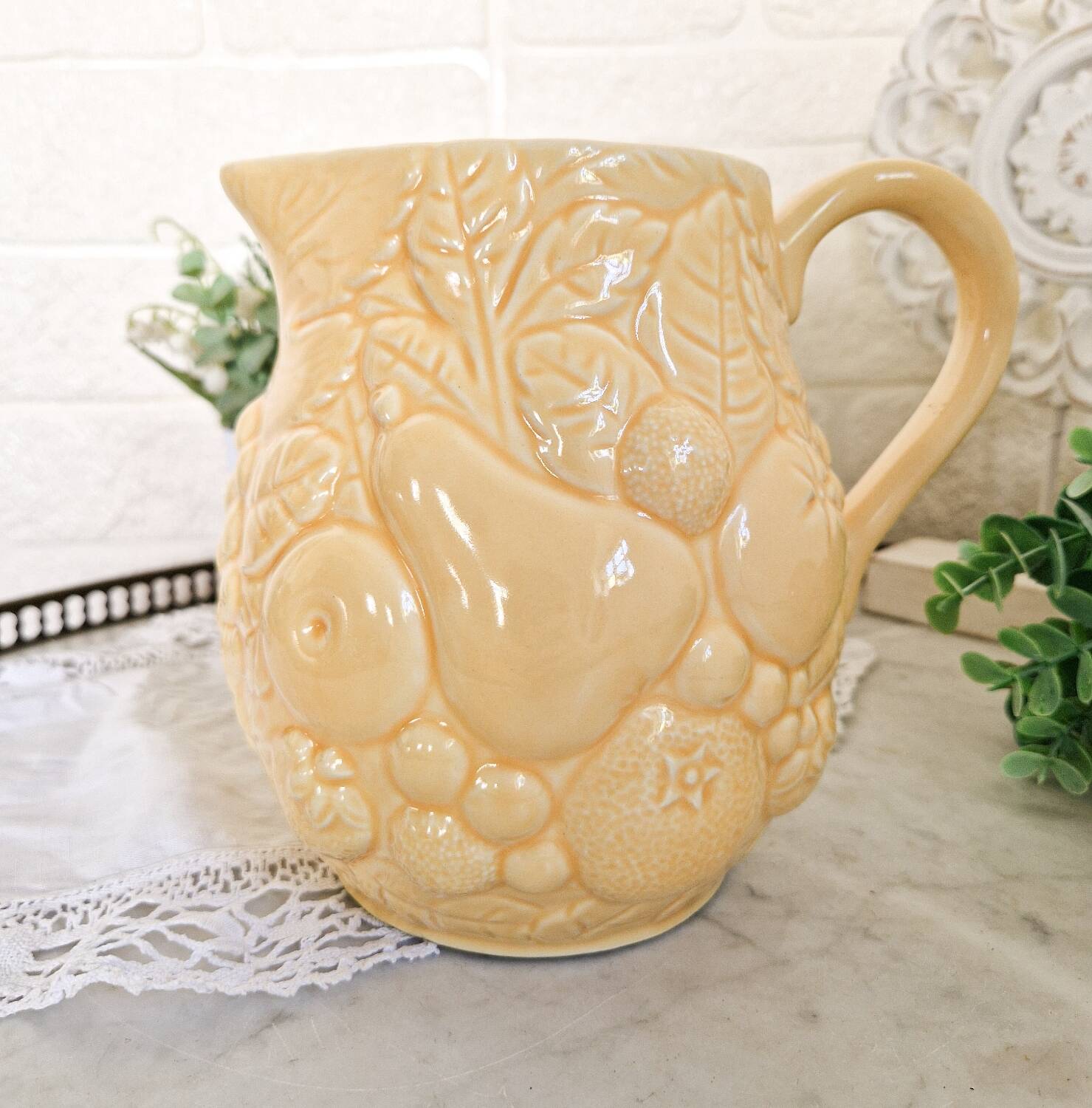 Vintage yellow pitcher in fruit slip