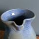 Enamel pitcher in pastel blue and green, signed