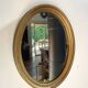 Oval mirror in gilded wood