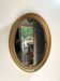 Oval mirror in gilded wood