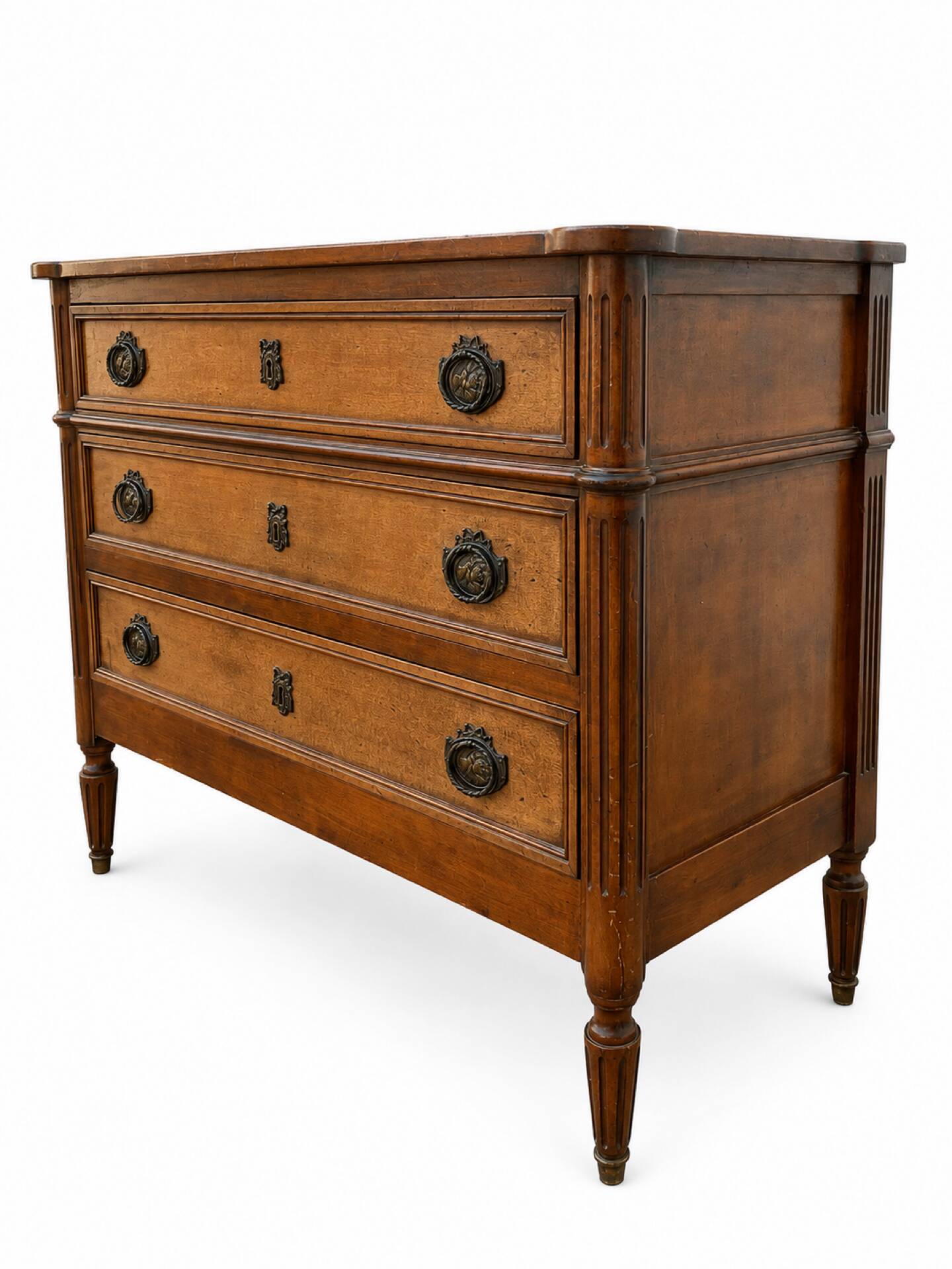 Light walnut commode in Louis XVI style with fluted motifs and three drawers.